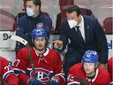 Canadiens assistant coach Luke Richardson has a conversation with defenseman Alexander Romanov as teammate Kale Clague looks on during a second period against the Washington Capitals in Montreal on Feb. 10, 2022.   