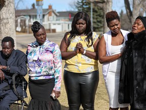Jal Acor Jal's father Julius Ater, aunts Akier Kuol and Achan Jal, mother Achang Jal and grandmother Abuk Diiene comfort each other as they speak to the media in Calgary on Wednesday, April 6, 2022, police said on Wednesday they had made an arrest in the Murder of a 16 year old.