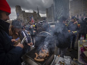 Tigers fans tailgate outside Comerica Park in downtown Detroit where the Detroit Tigers are hosting the Chicago White Sox in the home opener to kick off the 2022 season of Major League Baseball, on Friday, April 8, 2022.