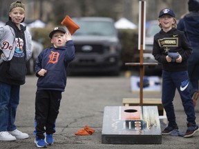 Trevor Bo, 5, throws a bean bag during a game of corn hole while his parents tailgate outside of Comerica Park in downtown Detroit, where the Detroit Tigers are hosting the Chicago White Sox to kick off the 2022 season of Major League Baseball, on Friday , April 8, 2022.