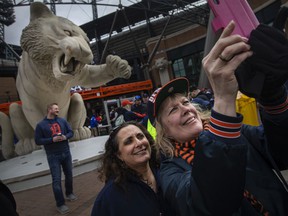 Teresa Weiss and Tina Humes, left, take a photo outside of Comerica Park in downtown Detroit, where the Detroit Tigers are hosting the Chicago White Sox to kick off the 2022 season of Major League Baseball, on Friday, April 8, 2022.