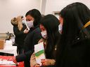 Mask-wearing attendees of a health information fair for migrant workers in Leamington on April 3, 2022.