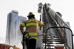 Edmonton Fire Rescue Services firefighters extinguish a fire in an abandoned building near 101 Street and 106 Avenue in Edmonton, on Sunday, April 10, 2022. A previous fire at the site destroyed the closed Mila Pub.