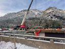 A replacement piece is lowered into place at the damaged Jessica Bridge, southbound side, on the Coquihalla freeway (Hwy. 5).  The bridge was damaged during the atmospheric river rains of Nov, 14-15.