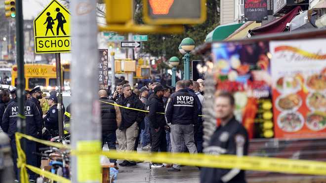 New York City Police Department personnel gather at the subway entrance.  x20;stop in the Brooklyn borough of New York on Tuesday, April 12, x20;2022.  Five people were shot Tuesday morning at a subway station in Brooklyn, New York, law enforcement sources said.