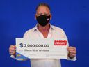 Glenn Weitz of Windsor holds his M prize check that he won playing Instant Triple Millions.