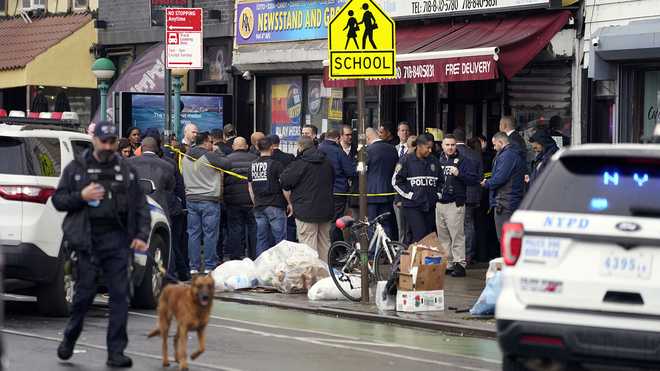 New&#x20;York&#x20;City&#x20;Police&#x20;Department&#x20;personnel&#x20;gather&#x20;at&#x20;the&#x20;entrance&#x20;to&#x20;a&#x20;subway&#x20;stop&#x20;in&#x20;the&#x20;Brooklyn&#x20;borough&#x20;of&#x20;New&#x20;York,&#x20;Tuesday,&#x20;April&#x20;12,&#x20;2022.