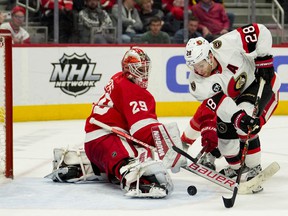 Detroit Red Wings goaltender Thomas Greiss knocks the puck away from Ottawa Senators right wing Connor Brown during the third period at Little Caesars Arena.