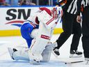 Canadiens goaltender Jake Allen (34) reacts after suffering an apparent injury during the first period against the Toronto Maple Leafs at Scotiabank Arena in Toronto on Saturday, April 9, 2022.