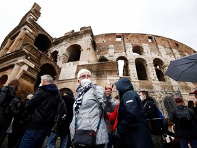 People wait in line before entering the Colosseum as Italy begins to ease some COVID-19 restrictions, lifting the obligation to show a health pass to sit at outdoor restaurants, access museums and other activities in Rome, Italy, April 1, 2022.