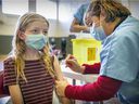 Katherine Love, 11, of Beaconsfield gets vaccinated for COVID-19 at a clinic held at Beurling Academy in Verdun on Nov. 27, 2021.