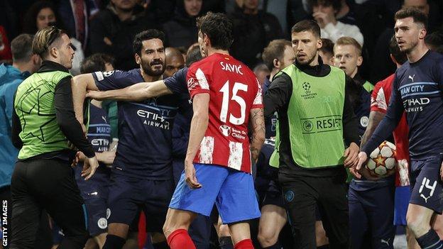Manchester City and Atletico Madrid players (including Jack Grealish - left - and Stefan Savic - centre) clash