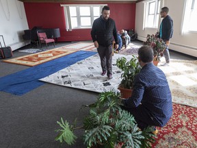Yasin Cetin, Outreach and Engagement Advisor of the Muslim Association of Canada helps to prepare a room as the McDougall United Church hosts a partnership between the McDougall United congregation and the Muslim Association of Canada (MAC) Edmonton Chapter.  The two congregations gathered ahead of their Good Friday service and Friday Prayers, respectively, in recognition of their collaborative efforts to restore and redevelop McDougall United Church as an inclusive community hub on Friday, April 15, 2022 in Edmonton.  Greg Southam - Postmedia