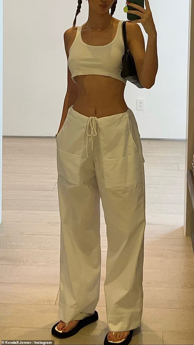 Light Look: She went braless under a white tank top and added a pair of white wide-leg pants from Local European