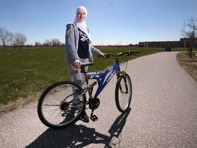 Jana Jandal Alrifai, 19, is shown with her bike near her south Windsor home on Saturday, April 16, 2022. She says the city needs more bike lanes.