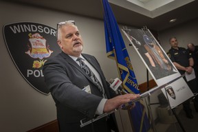 Supt.  Jason Crowley of Windsor police investigations speaks to media next to a surveillance image of the suspect at large in relation to the April 9 shooting at Super Bowl Lanes in the Forest Glade Area.  Photograph taken April 12, 2022.