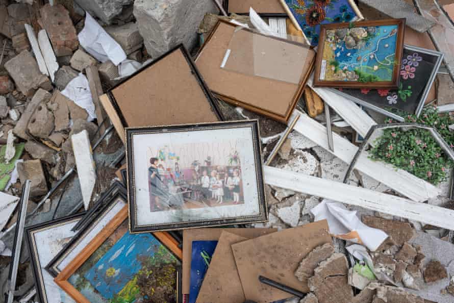 A damaged photo frame with a photo of children performing seen outside a kindergarten that was bombed west of Kyiv on 19 April.