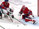 Canadiens defenseman Chris Wideman gets a minor penalty for hooking Minnesota's Kevin Fiala in front of goalie Carey Price during the first period Tuesday night at the Bell Center.