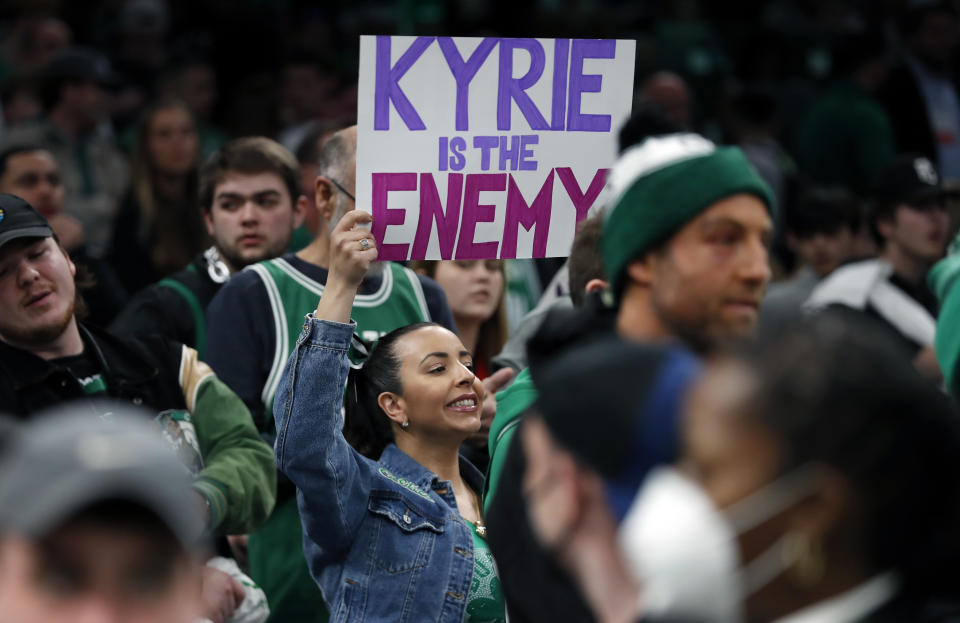 A Boston Celtics fan holds up a sign that reads: 