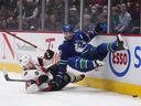Ottawa Senators' Connor Brown, left, and Vancouver Canucks' Oliver Ekman-Larsson collide during the first period of an NHL hockey game in Vancouver, BC, Tuesday, April 19, 2022.