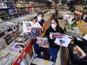 Liam O'Donnell (left) and Aimee Charette (right) of Dr. Disc Records in downtown Windsor show some vinyl goods in preparation for Record Store Day on April 23. Photographed April 20, 2022.