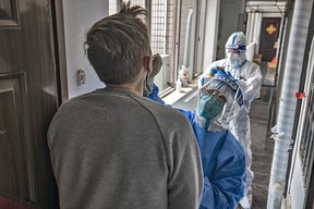 Victoria native Stewart Jensen undergoes door-to-door PCR testing in his building in Shanghai.  Photo: Matjaz Tancic.