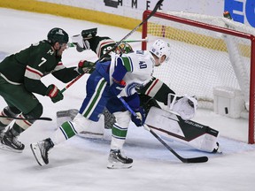 Vancouver Canucks center Elias Pettersson scores against Minnesota Wild goalie Cam Talbot to put the visitors into a 3-2 lead in the second period Thursday in St. Paul, Minn.