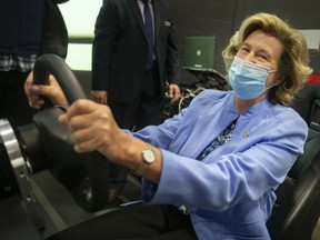 Helena Jaczek, Minister of Federal Economic Development Agency for Southern Ontario, gets behind the wheel in the VR Cave at the Invest WindsorEssex Automobility and Innovation Centre, on Thursday, April 21, 2022.
