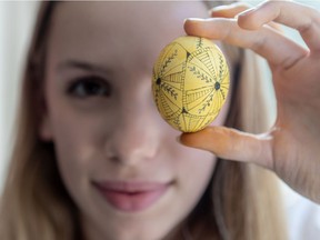 Teya Konanec, Natalia Hrycay's daughter, shows an early stage of the Ukrainian egg she is designing.  She began to learn to decorate pysanky at the age of three.