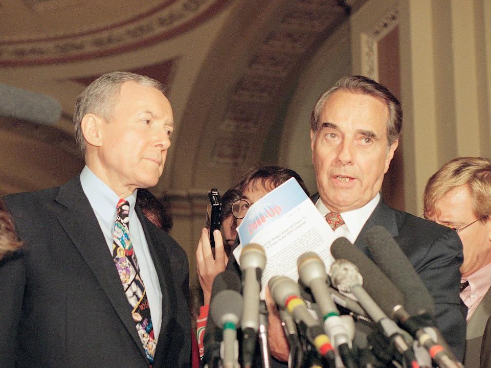 Senate Minority Leader Bob Dole of Kansas, right, joined by Sen. Orrin Hatch, R-Utah, holds a letter signed by 40 senators urging negotiations as he meets with reporters on Capitol Hill in Washington, on Tuesday August 23, 1994 to discuss the crime.  invoice.  Republican senators on Tuesday demanded that Democrats make some changes to the $30 billion crime bill, threatening to hold the votes to jeopardize the bill's future.  (AP Photo/John Duricka)