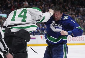 Vancouver Canucks' Luke Schenn, right, and Dallas Stars' Jamie Benn fight during the second period of an NHL hockey game in Vancouver, BC, Monday, April 18, 2022.