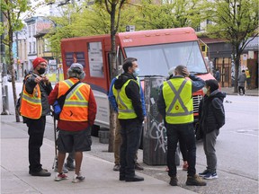 Canada Post delivery workers meet on E. Hastings St. as workers have complained of unsafe conditions and refused to deliver mail in the downtown eastside.  Nick Procaylo photo.