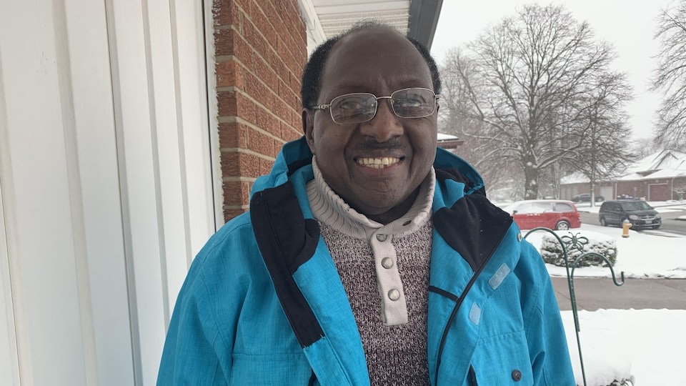 Fulgence Niyomugabo photographed outside in front of a building on a snowy day.