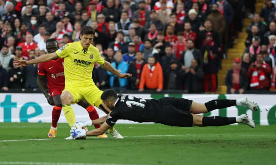 Villarreal's Pau Torres protects the ball from Liverpool's Sadio Mane as his goalkeeper Geronimo Rulli lunges at him.