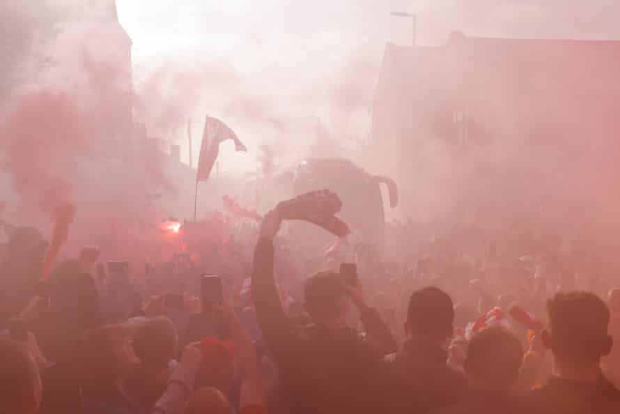 Liverpool fans celebrate the arrival of the Liverpool team bus.