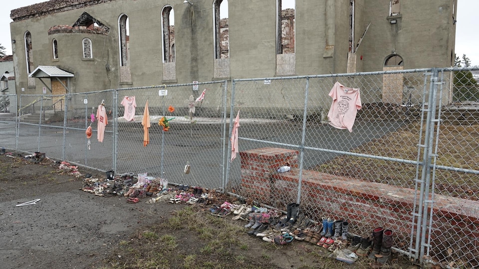 Shoes and clothes were placed in front of the burnt church in Listuguj.