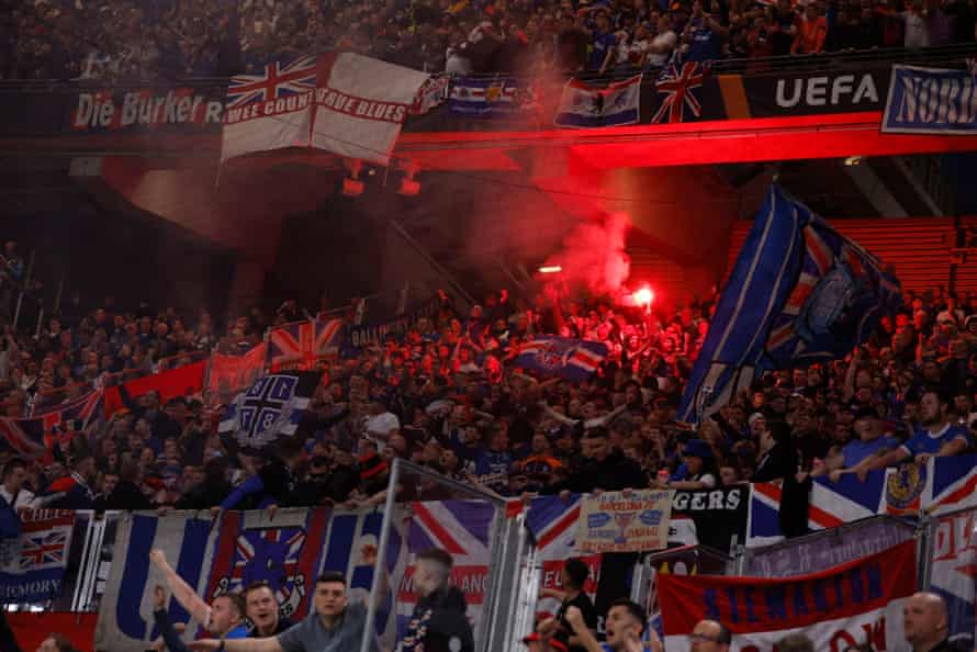 Rangers fans light flares inside the stadium before the game.