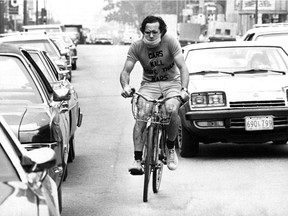 “Bicycle Bob” Silverman wears a mask while cycling in traffic in Montreal in 1976. (Jean-Pierre Rivest, Montreal Gazette) This photo was published in the Gazette on Oct. 12, 1976.