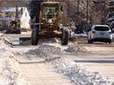 A grader works along 112 Avenue NW as the City of Edmonton responds to a recent snowfall during a Phase 1 Parking Ban in Edmonton, on March 6, 2022. 