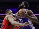 Joel Embiid #21 of the Philadelphia 76ers drives against Khem Birch #24 of the Toronto Raptors in the first quarter during Game 5 of the Eastern Conference First Round at Wells Fargo Center on Monday night.