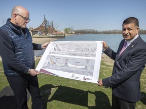 Major Drew Dilkens and Ward 7 Coun.  Jeewen Gill, hold up a drawing of the proposed changes to Sand Point Beach, during a press event on Thursday, April 28, 2022.