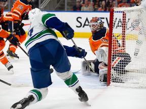 EDMONTON, AB – APRIL 29: Goaltender Mikko Koskinen #19 of the Edmonton Oilers makes a save against Brad Hunt #77 of the Vancouver Canucks during the first period at Rogers Place on April 29, 2022 in Edmonton, Canada.