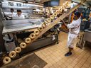 Fairmount Bagel, in Montreal on Thursday September 5, 2019, turns 100 years old this Saturday.  Baker Sathees Senarajah tosses another row of finished bagels into a basket.  Dave Sidaway / Montreal Gazette ORG XMIT: 63097