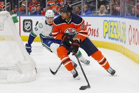 Edmonton Oilers forward Evander Kane (91) looks to make a pass in front of Vancouver Canucks defensemen Tyler Myers (57) during the third period at Rogers Place on Friday.