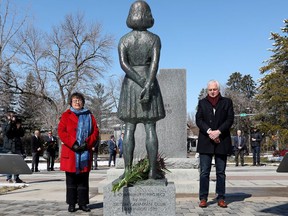 Senator Paula Simons, left, and Honorary Consul of the Netherlands Jerry Bouma pause after laying flowers at the Anne Frank statue and cenotaph in Edmonton's Light Horse Park, 10324 85 Ave., Wednesday, April 20, 2022. Five new educational panels were unveiled in the park.