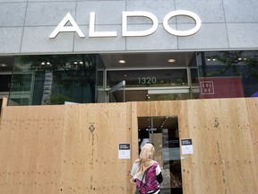 A customer waits to enter an Aldo store in Montreal in 2020.