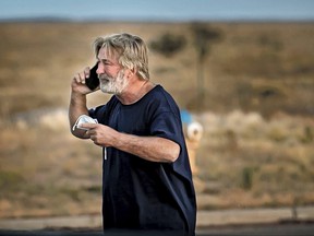 Alec Baldwin speaks on the phone in the parking lot outside the Santa Fe County Sheriff's Office in Santa Fe, NM, after he was questioned about a shooting on the set of the film "rust" on the outskirts of Santa Fe, Thursday, Oct. 21, 2021.