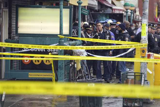 New York City Police Department personnel gather at the subway entrance.  x20;stop in the Brooklyn borough of New York on Tuesday, April 12, x20;2022.  Multiple people were shot and wounded Tuesday at a New York City subway station during a morning rush hour in an attack that left wounded passengers bleeding on a train platform.