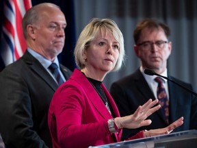 File photo: Provincial health officer Dr. Bonnie Henry responds to questions while BC Premier John Horgan, back left, and Health Minister Adrian Dix listen during a news conference about the provincial response to the coronavirus, in Vancouver, on March 6, 2020.