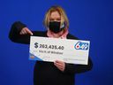 Iris Hitler of Windsor points to her prize check from playing Lotto 6/49 in September 2021.